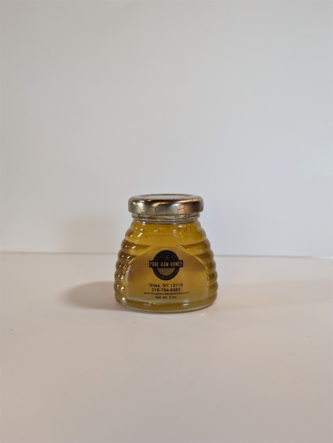 A glass jar of honey on the table