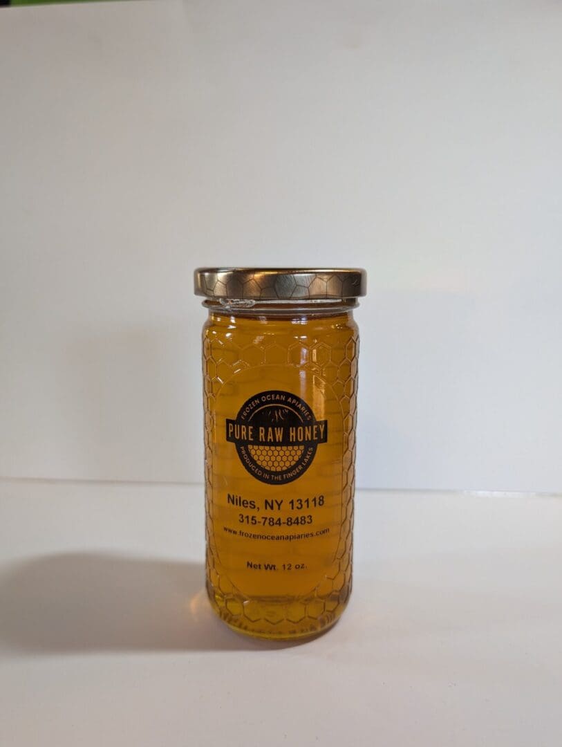 A jar of honey on top of a table with white background