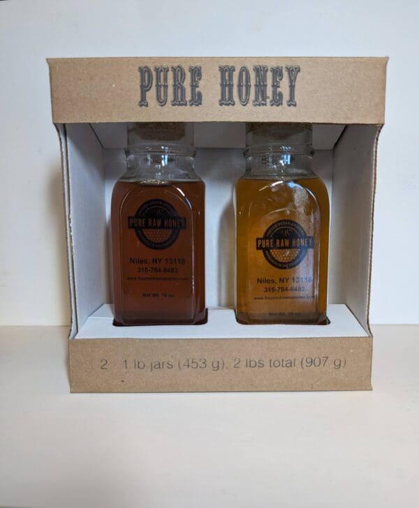 A box with two bottles of honey on top.