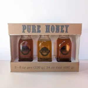 A box of honey is shown with three different jars.