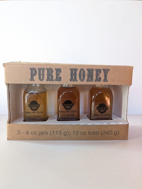 A box of honey is shown with three different types.